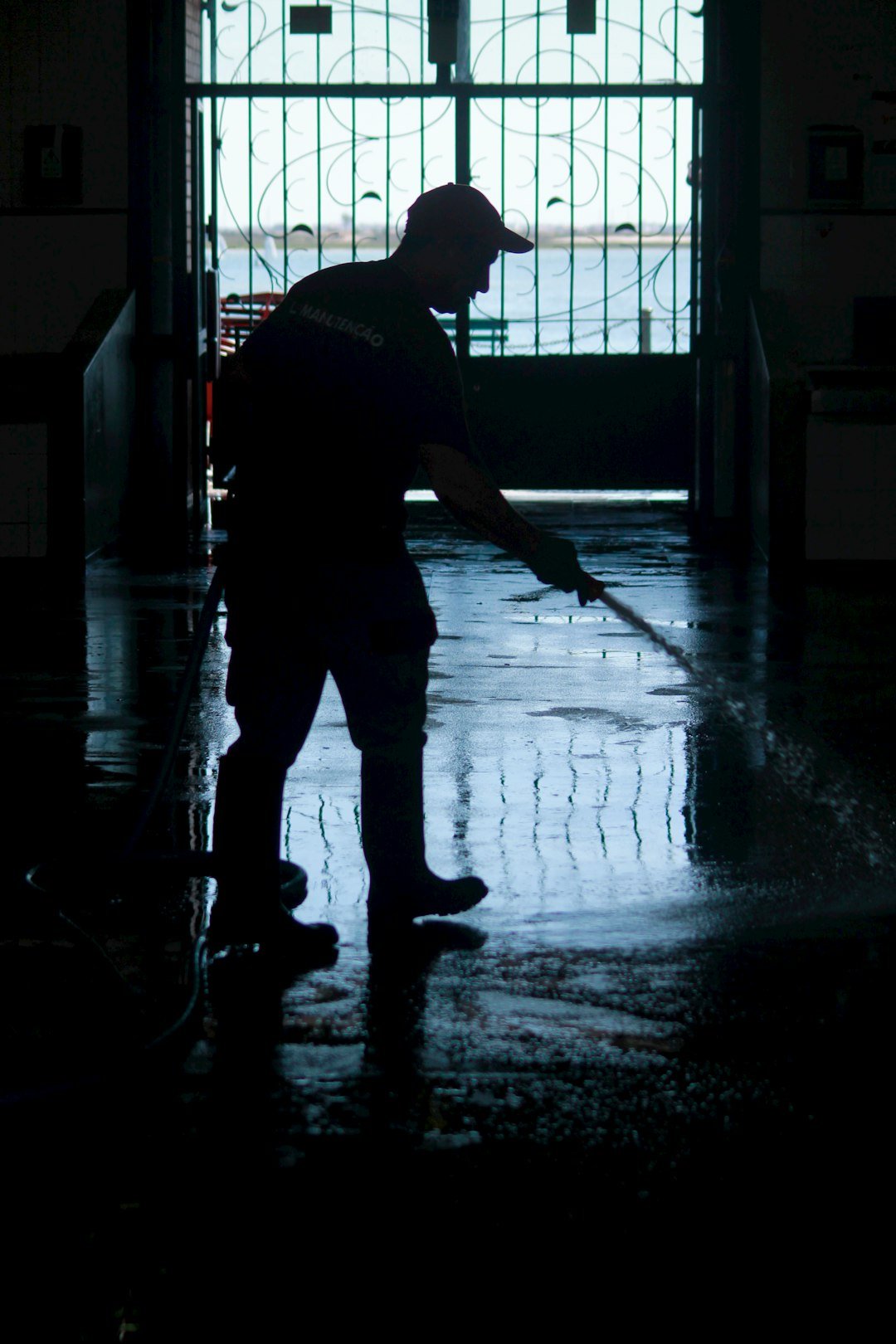 man-pouring-water-from-house-inside-building-uyga456mgwc